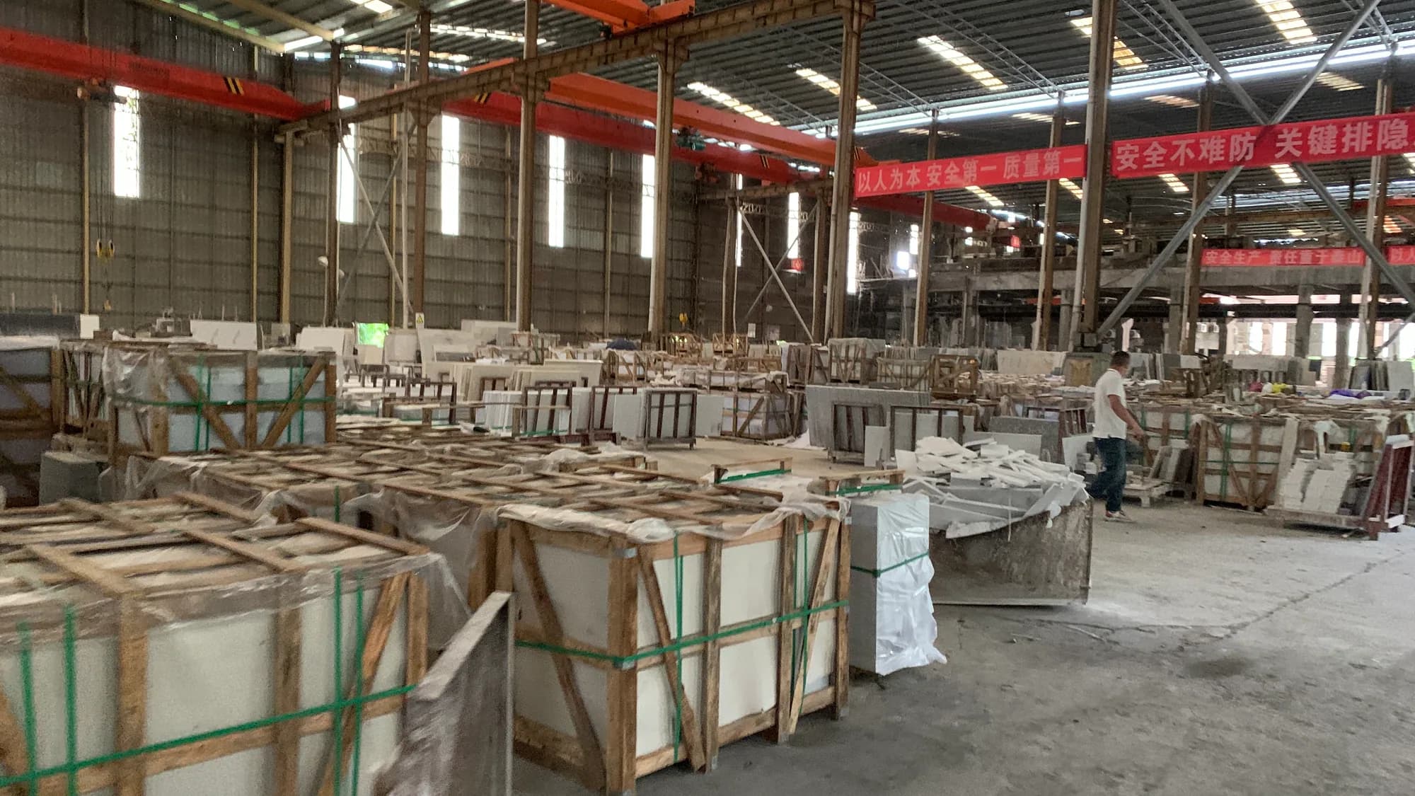 Workshop photo showing stone pieces and packing preparation areas.