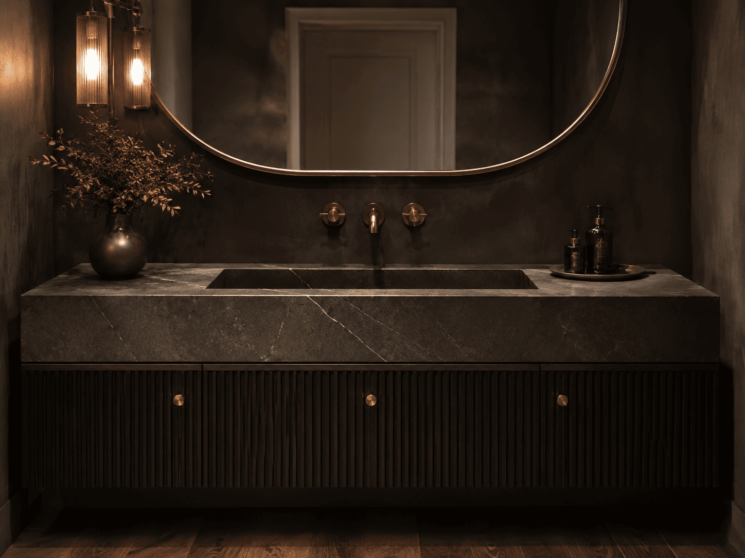 Illustrative dark vanity cabinet with a stone counter and basin.
