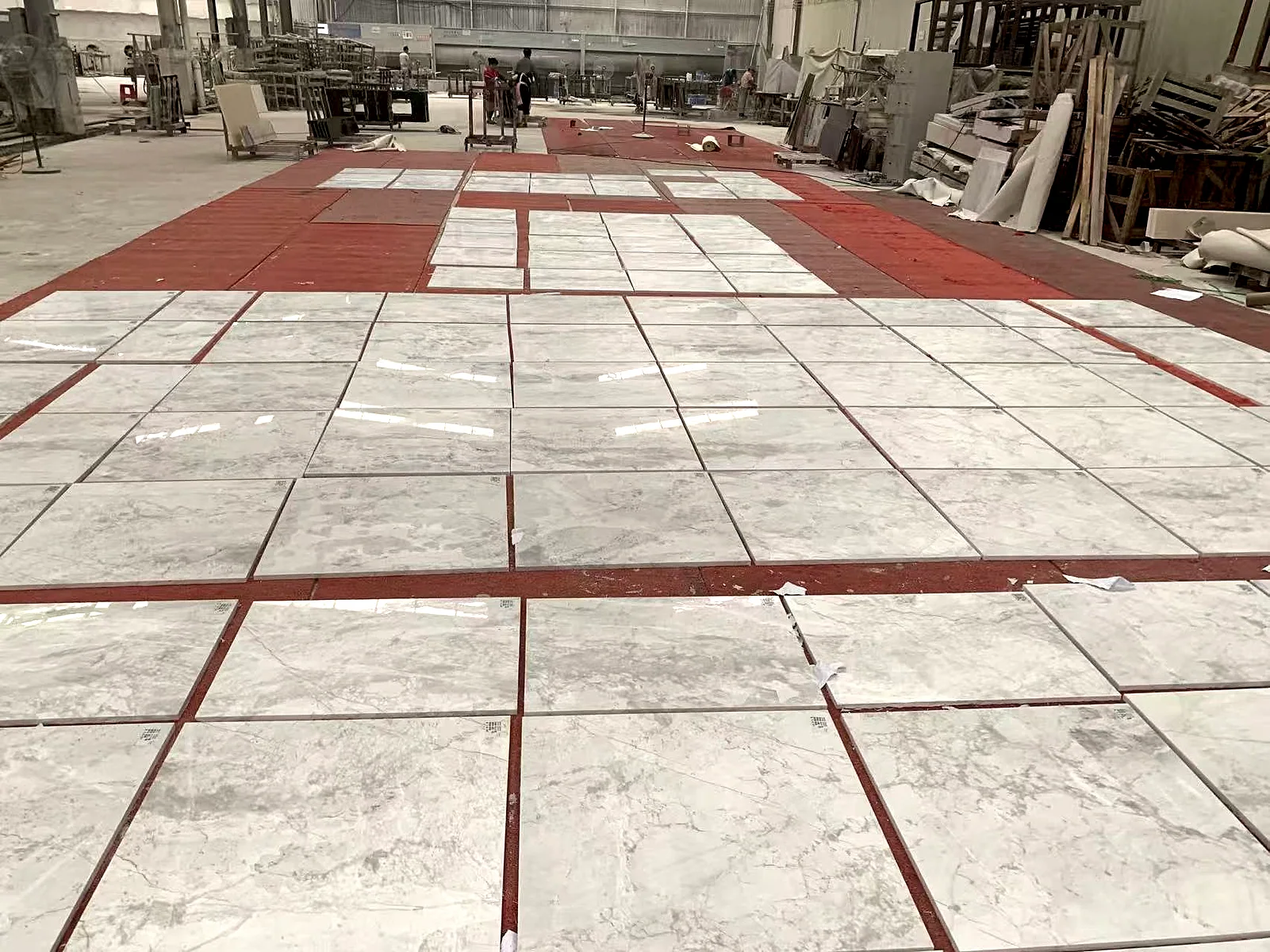 Stone tiles arranged in a surface layout with visible alignment lines.. Stone Tile Layout Reference