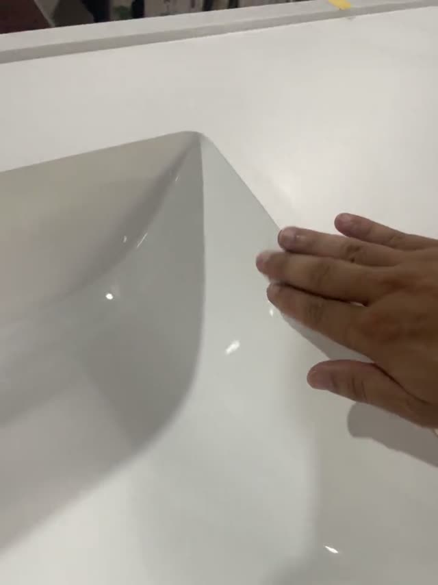 A close view of a formed basin and adjoining stone surface.