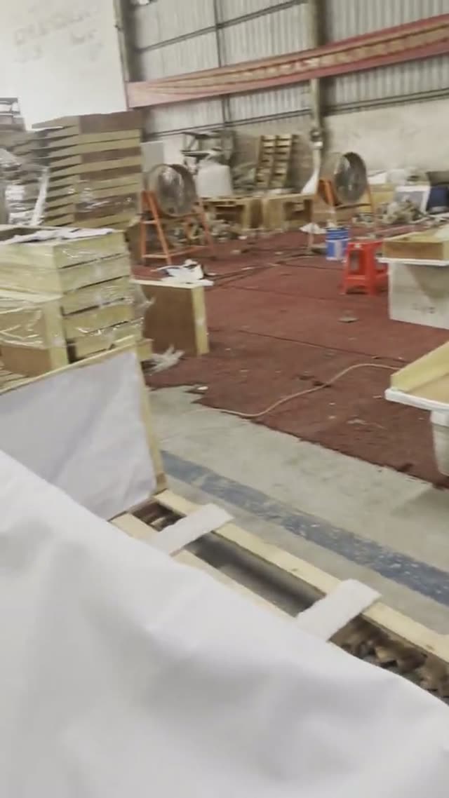 A view across stone workpieces and work areas.