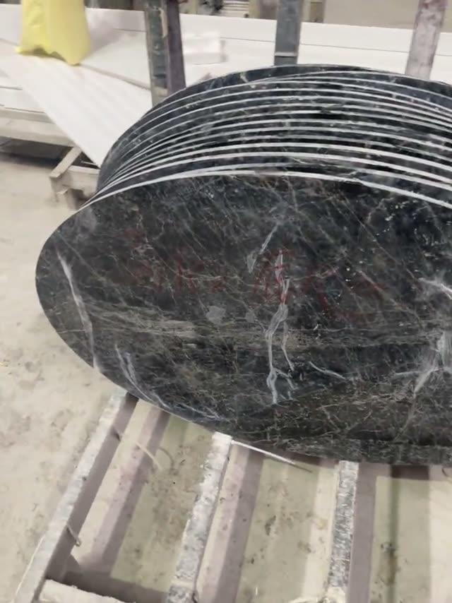 A close view of a round dark stone component and its surface.
