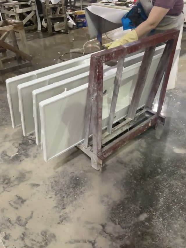 Stone workpieces are moved and positioned in a workshop area.