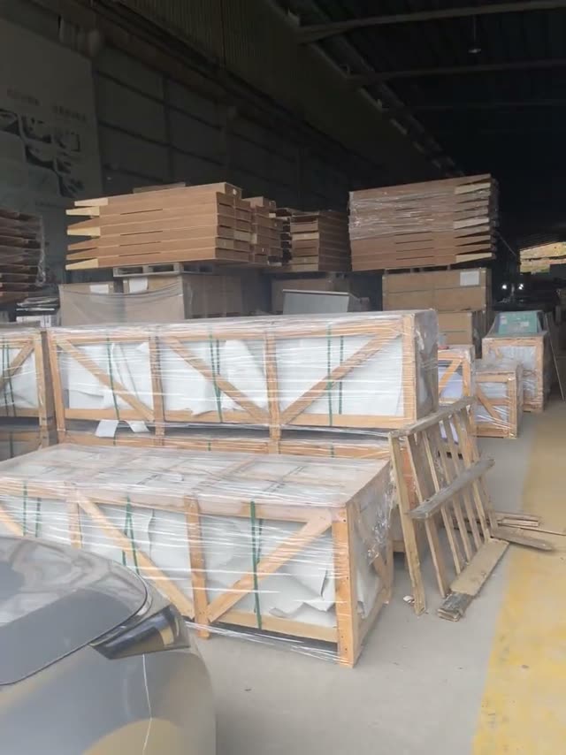 Stone components are staged on supports in a workshop area.